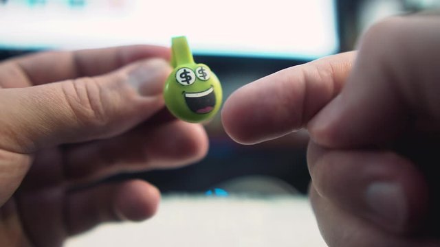 The guy clicks his finger on a cool silicone toy in his hands