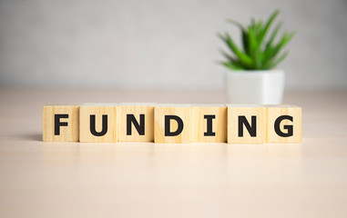 Funding Word Written In Wooden Cube, business concept.