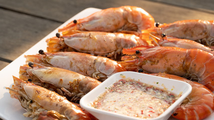 An outdoor barbecue with huge tiger prawns , closeup ii