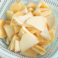 A person cooking Thai yellow curry with fish fillet and fresh ingredients