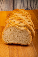 Sliced loaf of wheat bread on a wooden cutting Board. Close up.