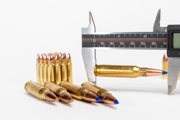 Caliper used to measure length of cartridge after seating bullet into brass during reloading or...