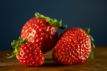 Closeup of three fresh and ripe strawberries