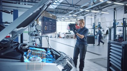 Female Mechanic Uses a Tablet Computer with an Augmented Reality Diagnostics Software. Specialist Inspecting Car's V6 Engine in Order to Find Broken Components. Hi-tech Modern Car Service. - Powered by Adobe