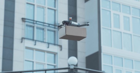 Woman getting her parcel from drone outdoors - Powered by Adobe