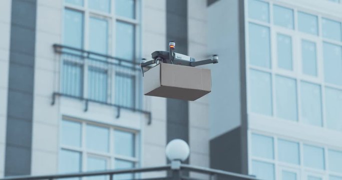 Woman getting her parcel from drone outdoors