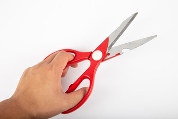 Man hand with Scissors with red plastic handles, on a white background.