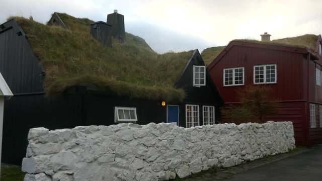 Left to right pan nordic style houses with grass roof in historical district of Tinganes in Torshavn, Faroe islands