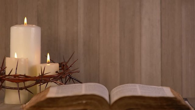 Candles Surrounded by Crown of Thorns and open Bible. Communion