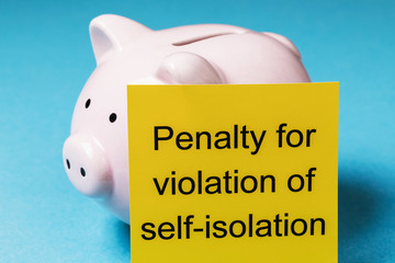 Piggy bank and note with text on a blue background. The concept of the fine for violation of the...