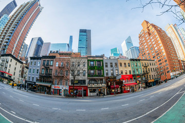 Street and facades of old colorful buildings in Manhattan, New York, USA