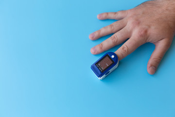 Pulse Oximeter On a male finger. Man using Oximeter. Healthy Concept