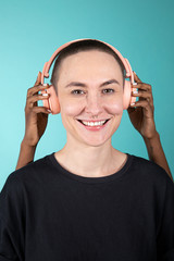 Skinhead woman listening to music