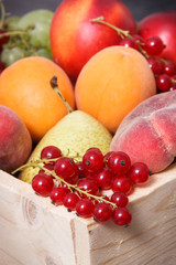 Naklejka na ściany i meble Fresh ripe fruits in wooden box. Food containing healthy minerals and vitamins