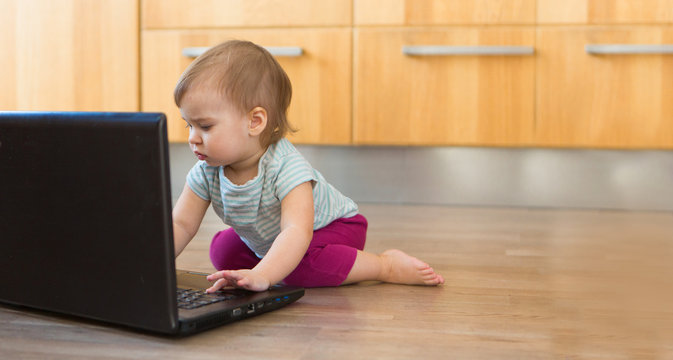small child plays on computer. The child Prodigy learns the techniques of business Planning, home work, quarantine, self-isolation, protection from coronavirus, virus
