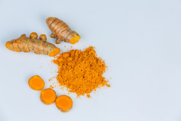 Turmeric root and turmeric powder isolated on white background close up.