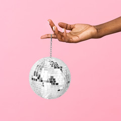 Shiny disco ball handing in a finger