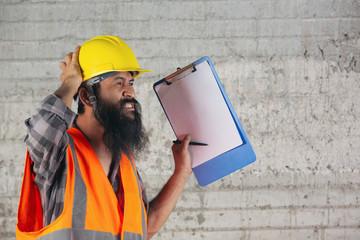 Construction worker with document, plan working for the inside building construction site.