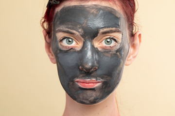 Woman doing a black charcoal mask