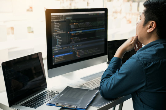 Asian man working code program developer computer web development working design software on desk in office.