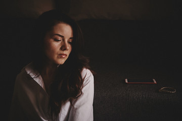 Photo of a girl in a white shirt, dark background