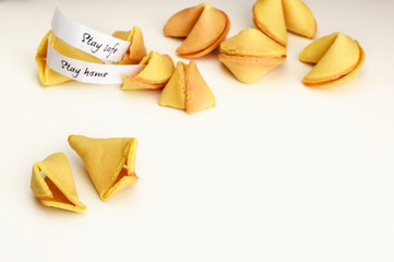 Stay home, Stay safe wishes in fortune cookies. Pile of Fortune cookies on a white background with copy space. Opened cookie. 