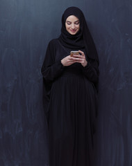 young modern muslim business woman using smartphone