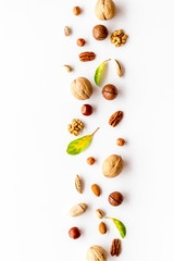 Nuts background - with almond, macadamia, walnut, hazelnut, pecans - on white table top-down copy...