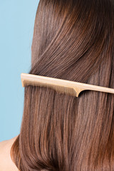 Woman combing her sleek hair