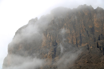 Fototapeta na wymiar The top of the Dolomites in Italy in the fog. Autumn foggy morning. Selective focus.