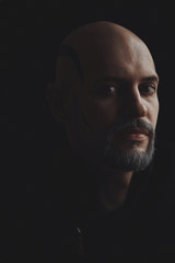 Man in sweater shaved bald head, white beard