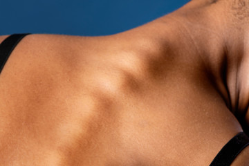 The spine of a tanned woman