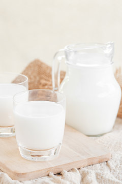 Milk.Milk bottle and milk glass on wooden table.Glass jug and glass with milk.Healthy eating concept