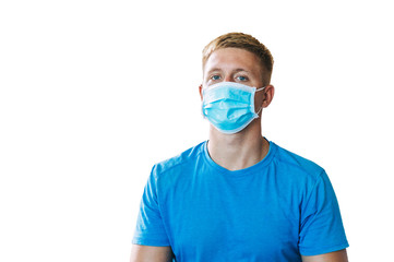Handsome young blond man in a blue T-shirt on white background in blue medicine protective mask, works from home, stay at home, сoncept of coronavirus quarantine, close-up