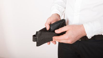 Bankruptcy - Business Person holding an empty wallet. Man showing  the inconsistency and lack of money and not able to pay the loan and the mortgage.