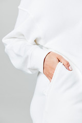 Hand the in white sweater pocket