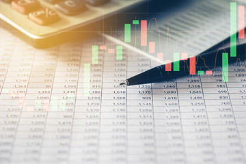 Pen and Calculator on accounting report with trading graph, Business and Financial concept. 