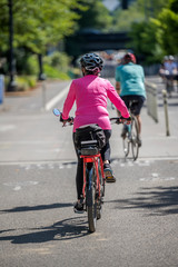 Fototapeta na wymiar Cyclists take a bike ride along a city street preferring an active lifestyle that is healthy