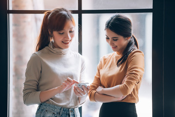 Group of Diversity Young Asian Businesspeople Friends Casual Meeting and Relax Together at Co-Working Space - Teamwork and Relax Concept