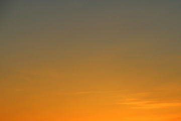 Sun below the horizon and fiery dramatic orange sky at sunset or dawn backlit by the sun. Place for text and design.