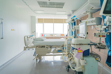 Empty adjustable patient's bed in hospital room for medical treatment and rehabilitation.