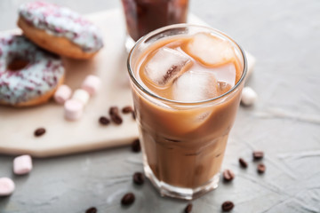 Glass of tasty iced coffee on grey background