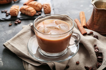 Glass cup of tasty iced coffee on table