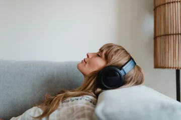  Woman listening to music at home during coronavirus pandemic © rawpixel.com