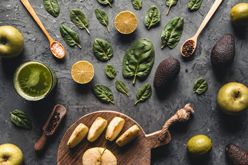 Spinach with lemon on a dark gray background. Wholesome food, vegan, eco products.
