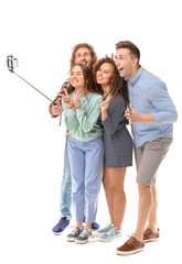 Fototapeta premium Friends taking selfie on white background