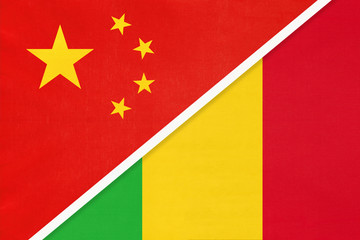 China or PRC vs Mali national flag from textile. Relationship between Asian and African countries.