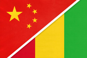 China or PRC vs Guinea national flag from textile. Relationship between Asian and African countries.