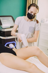 Obraz premium Laser hair removal in professional beauty studio. beauty parlor. Girl master makes hair removal