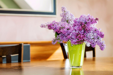 Bouquet of Purple Lilac  on a  Wooden Table .Spring Home Decoration 